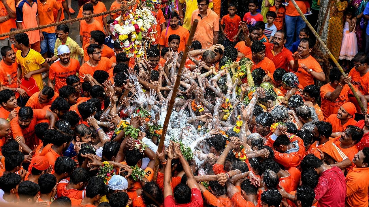 Krishna devotees participate in 'Dahi-Handi event during Janmashtami celebrations, in Navi Mumbai. Credit: PTI File Photo