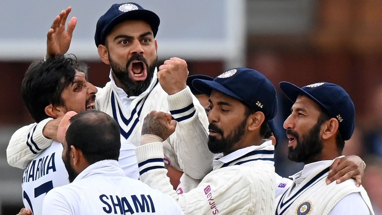 India's captain Virat Kohli (3L) celebrates with India's Ishant Sharma (L) and teammates after the successful appeal for the wicket of England's Jonny Bairstow on the fifth and final day of the second cricket Test match between England and India at Lord's cricket ground in London on August 16, 2021. Credit: AFP Photo