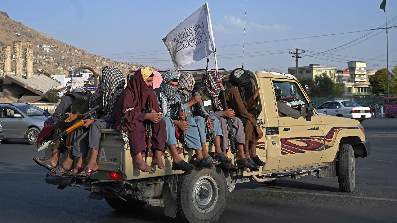 Taliban fighters in a vehicle patrol the streets of Kabul on August 23, 2021. Credit: AFP Photo
