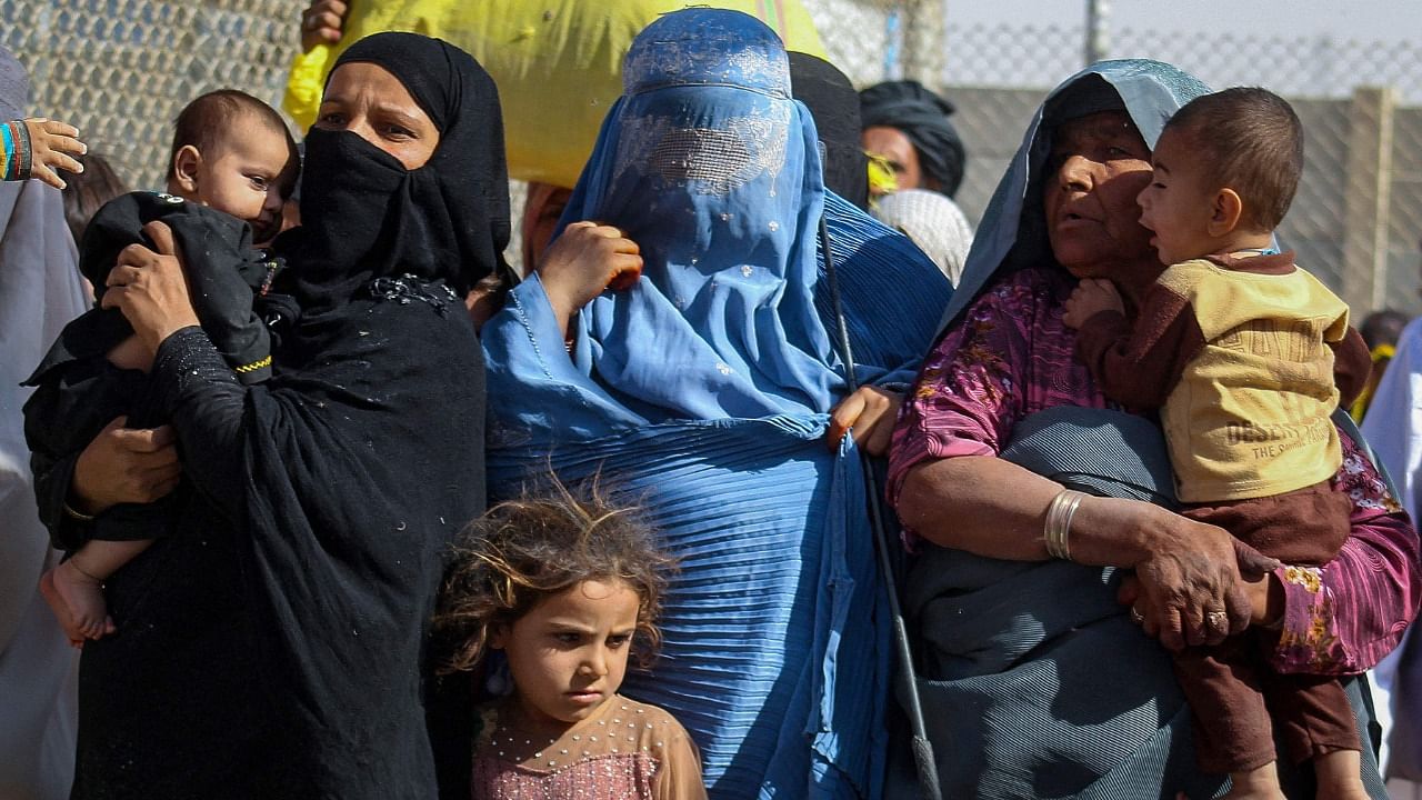 Afghan nationals arrive in Pakistan through the Pakistan-Afghanistan border crossing point in Chaman on August 24, 2021 following Taliban's military takeover of Afghanistan. Credit: AFP Photo