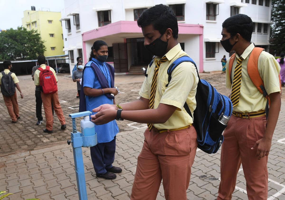 Students attend a class as the Karnataka Government allowed to reopen the schools to conduct the classes for 9th-10th and pre-university college, at T Dasarahalli, in Bengaluru. Credit: DH Photo