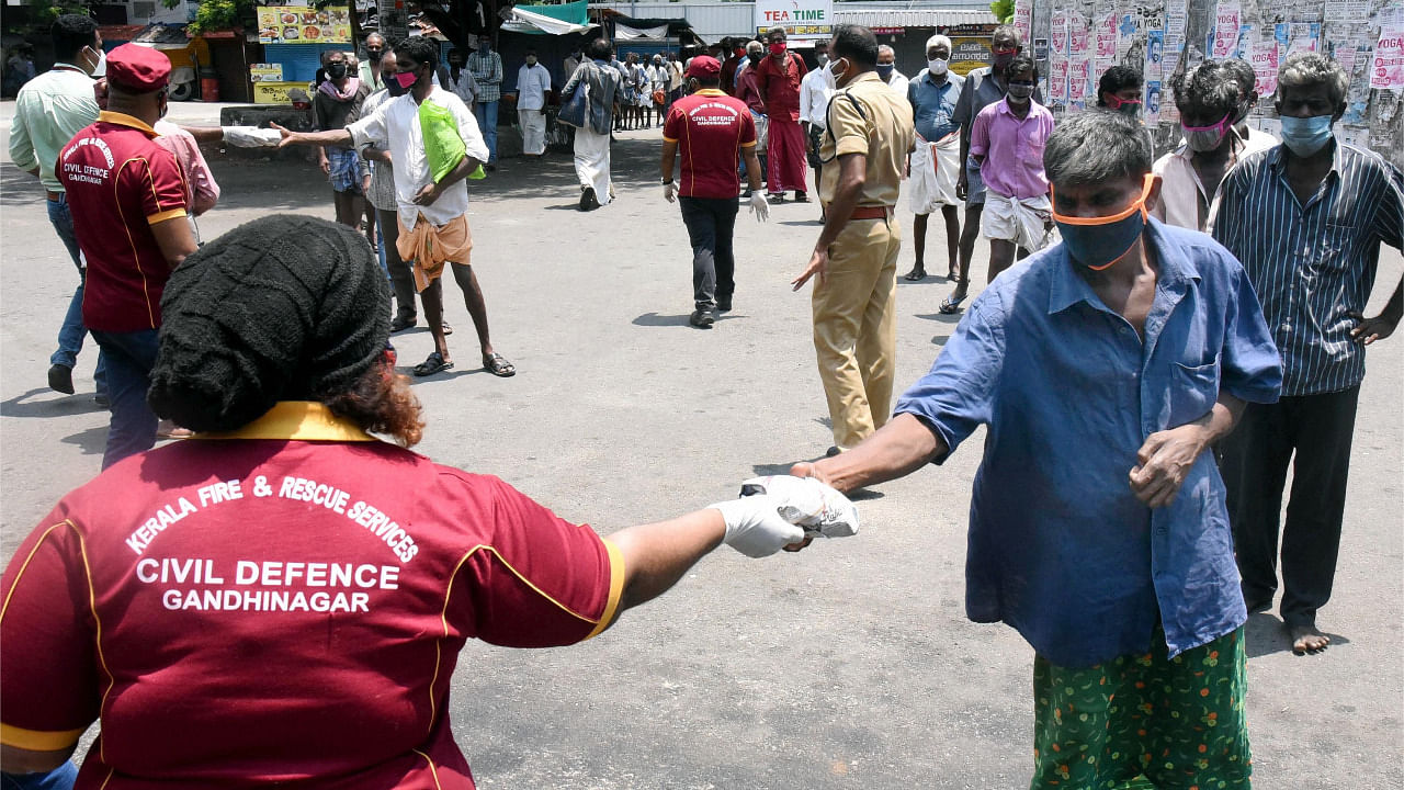 Kerala Fire and Rescue Services and Civil Defence workers provide food to people during Covid-induced lockdown to contain the coronavirus pandemic. Credit: PTI Photo
