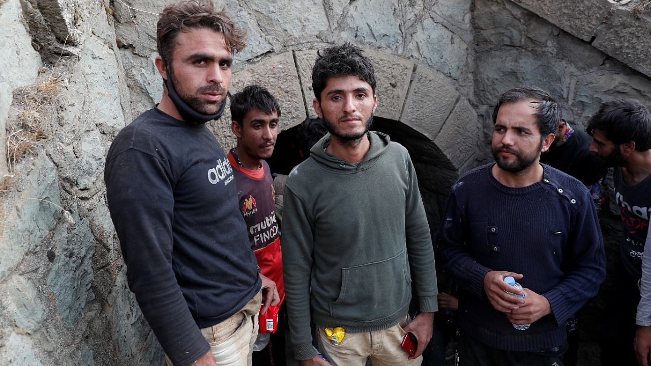 Muhammad Ali, an Afghan migrant from Khost who planned to found his own cryptocurrency mining business, center, and the other migrants hide from security forces. Credit: Reuters Photo