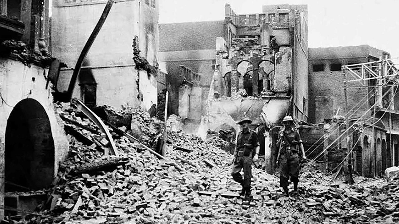 Indian soldiers walking through the debris of a building in the Chowk Bijli Wala area of Amristar during unrest following the Partition of India and Pakistan. Credit: AFP File Photo