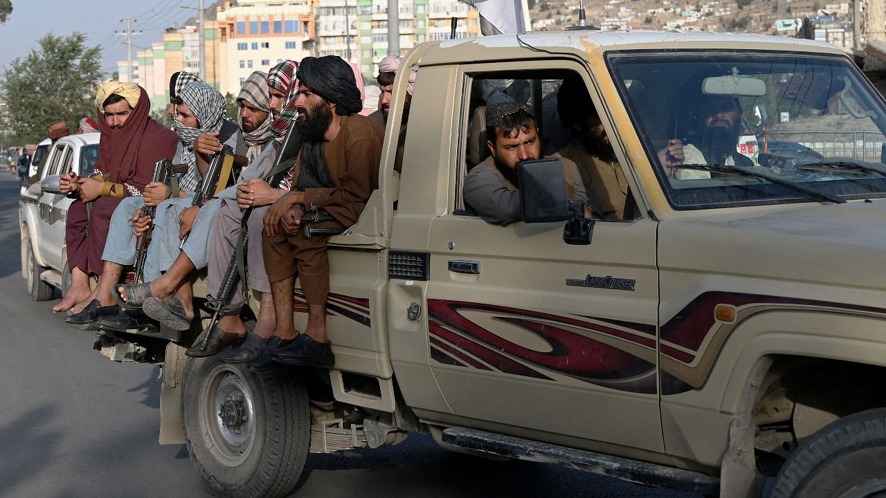Taliban fighters in a vehicle patrol the streets of Kabul. Credit: AFP Photo