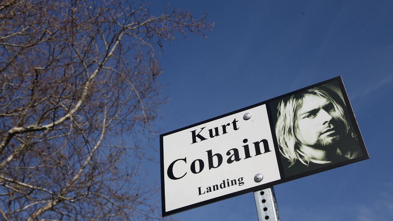 In this file photo a sign with the image of Kurt Cobain is seen in Kurt Cobain Park in Aberdeen, Washington on April 1, 2014, near the house where Cobain lived and committed suicide. Credit: AFP Photo