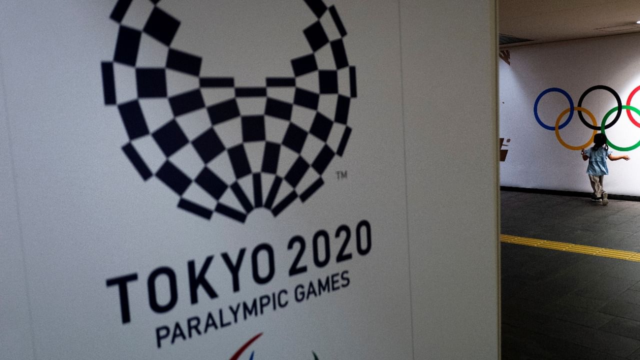A girl runs past Olympic rings and the logo of Tokyo 2020 Paralympic Games amid the coronavirus disease. Credit: Reuters File Photo