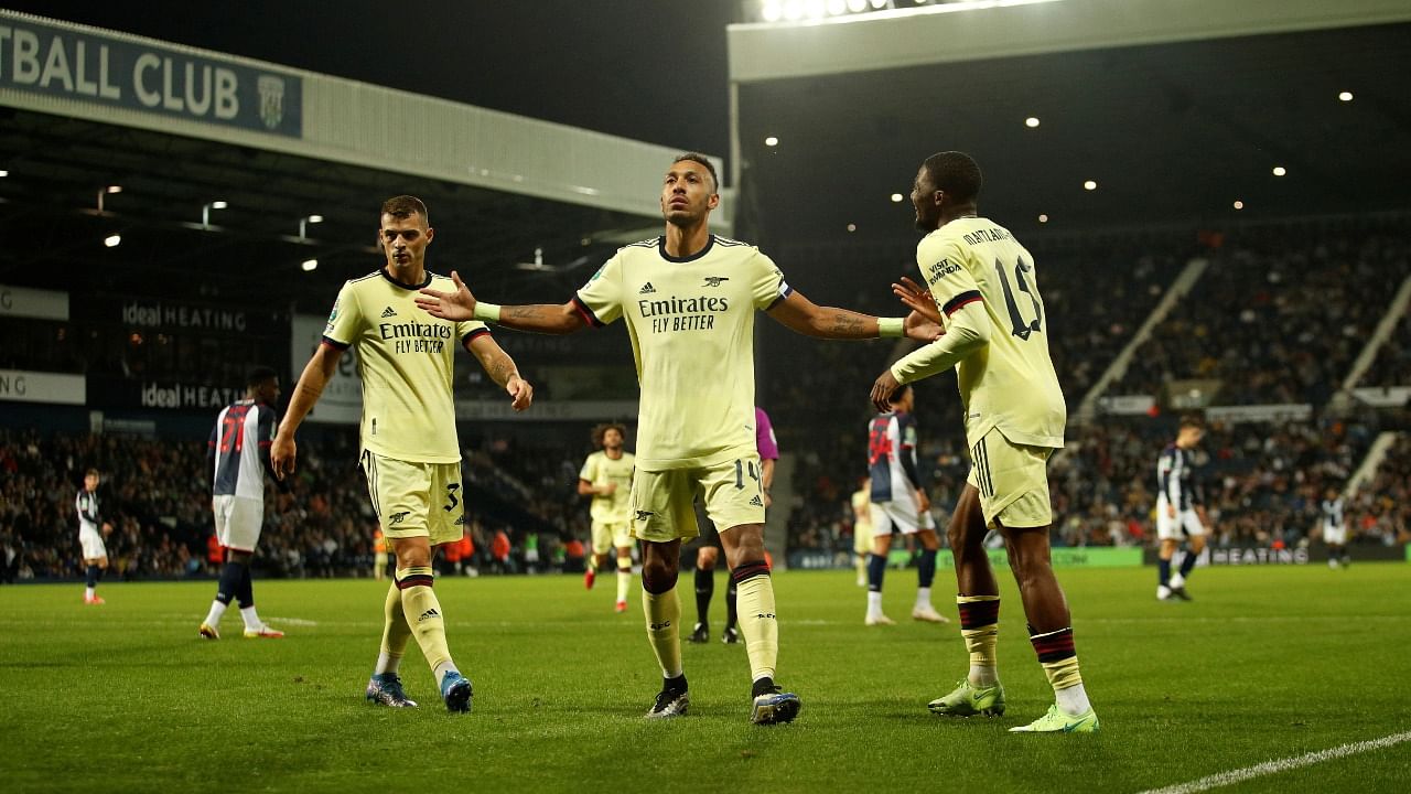 Arsenal's Pierre-Emerick Aubameyang celebrates scoring their fifth goal and his hat-trick with Granit Xhaka and Ainsley Maitland-Niles. Credit: Reuters photo