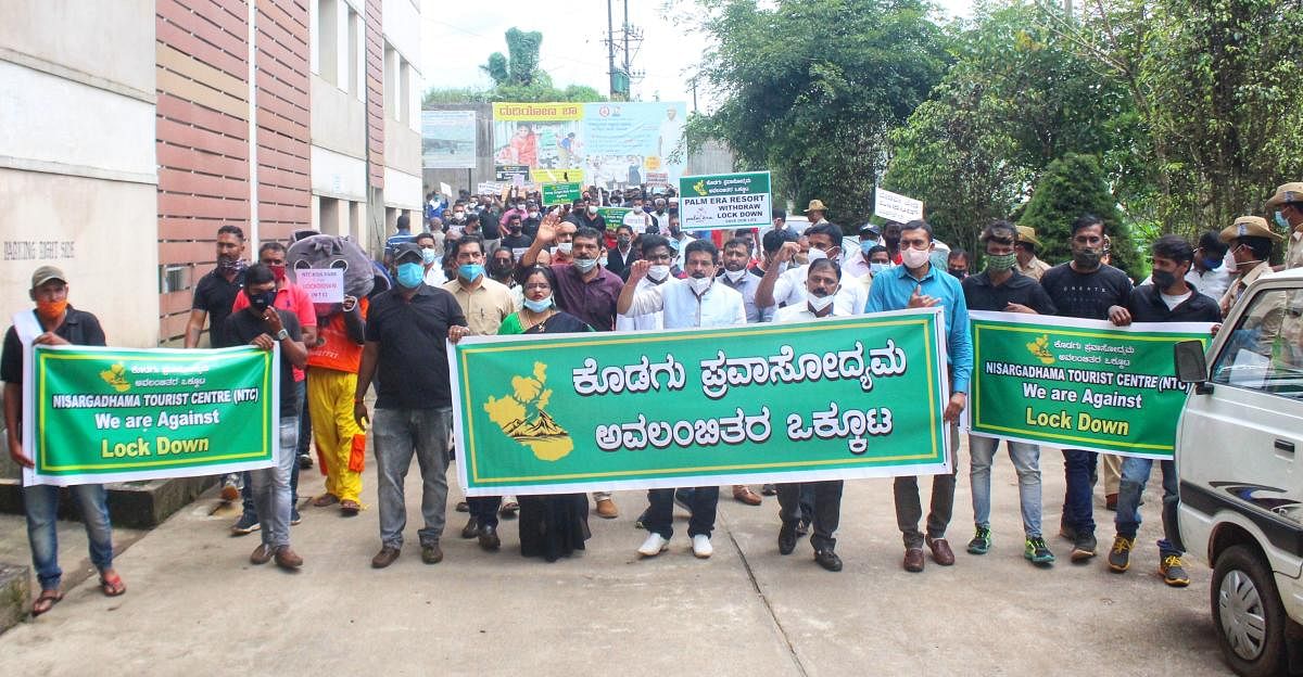 The workers dependent on the tourism sector staged a protest in Madikeri on Wednesday. Credit: DH photo