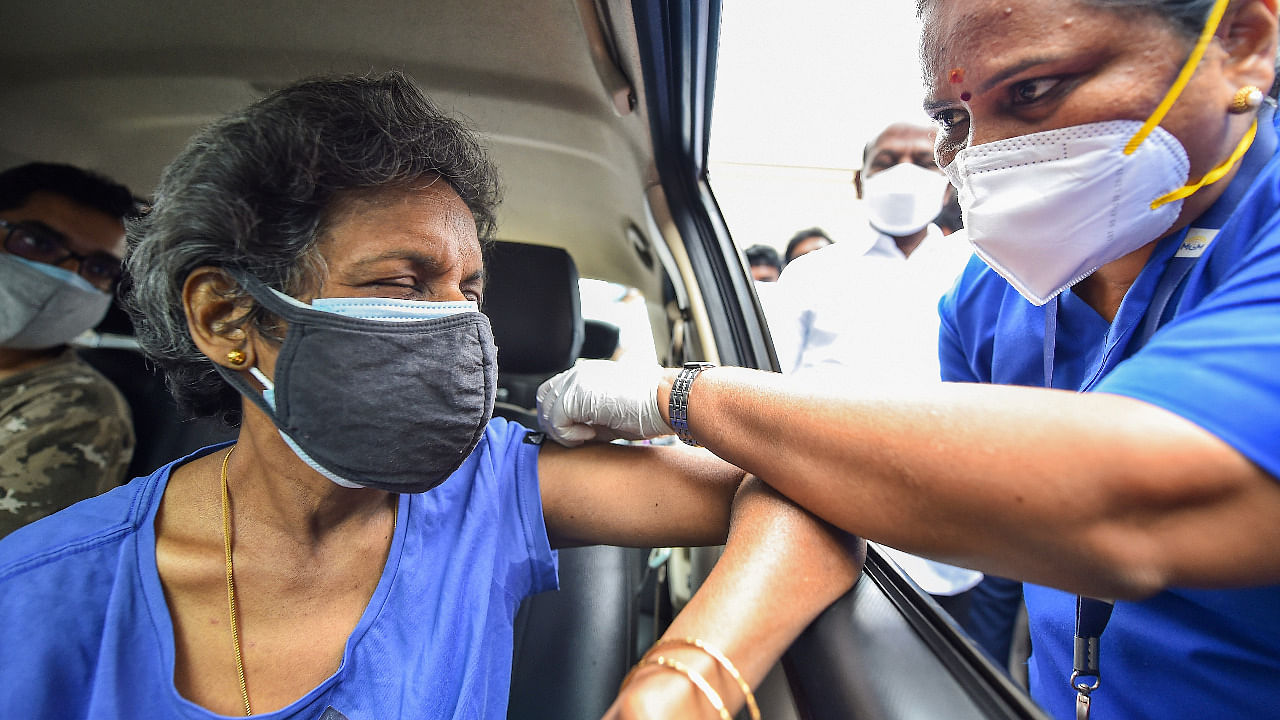A health worker administers a dose of the Covid-19 vaccine to a person at a drive-in vaccination centre, at MGM Hospital, in Chennai. Credit: PTI Photo