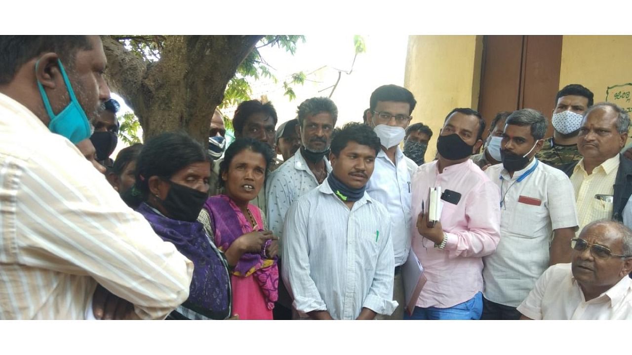 Food and Civil Supplies and Forest Minister Umesh Katti interacts with tribals at a hamlet in Gundlupet taluk in Chamarajanagar district on Thursday. Credit: DH Photo