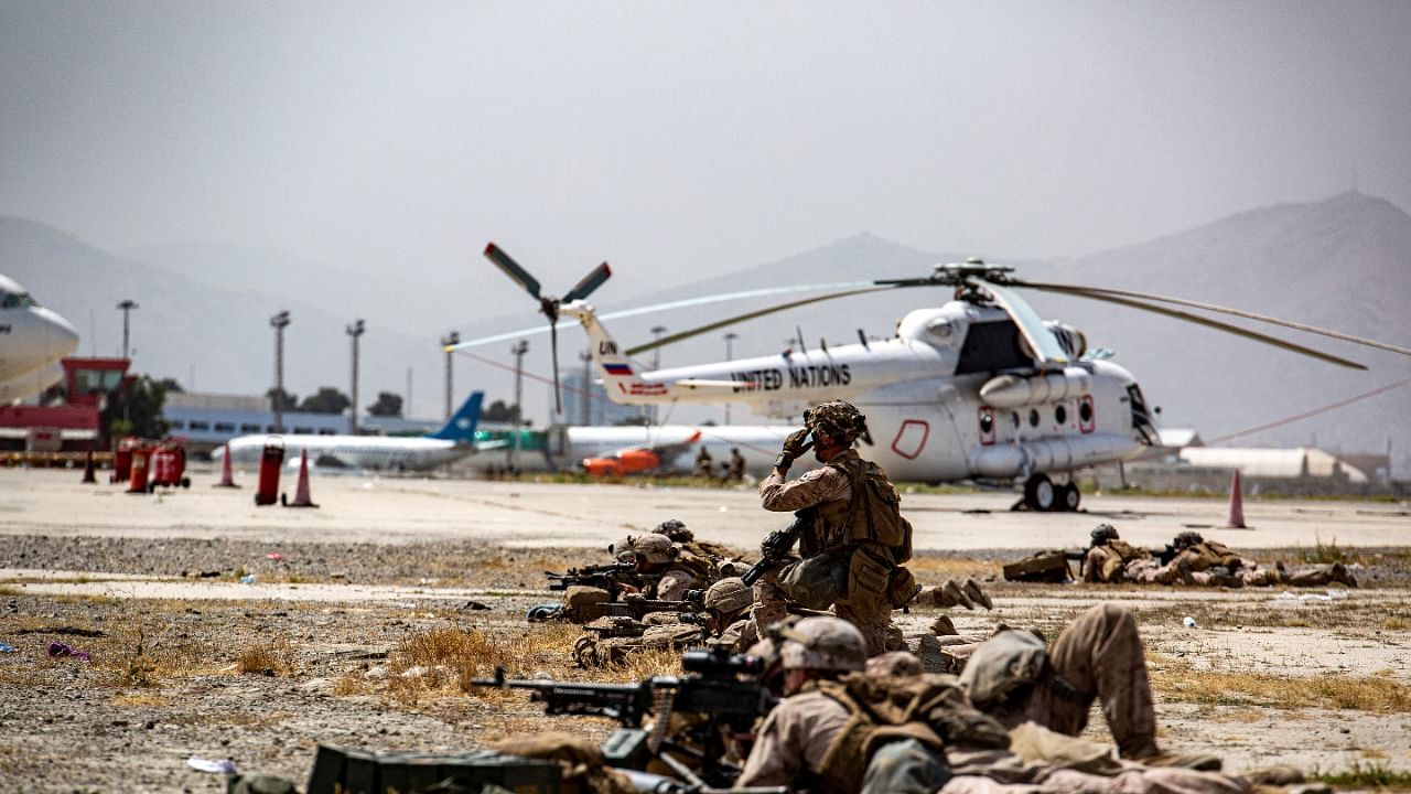 US Marines keep watch during an evacuation at Hamid Karzai International Airport. Credit: Reuters Photo