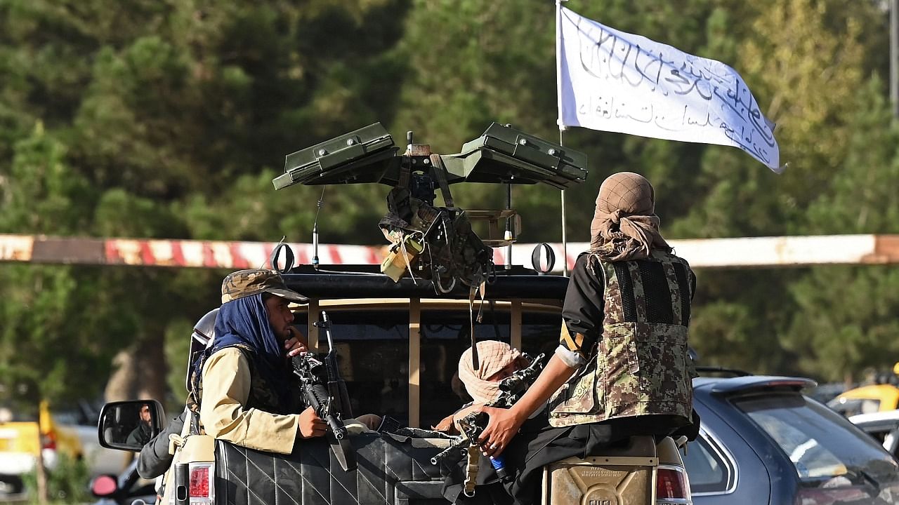 Taliban fighters in a vehicle patrol a street in Kabul. Credit: AFP Photo