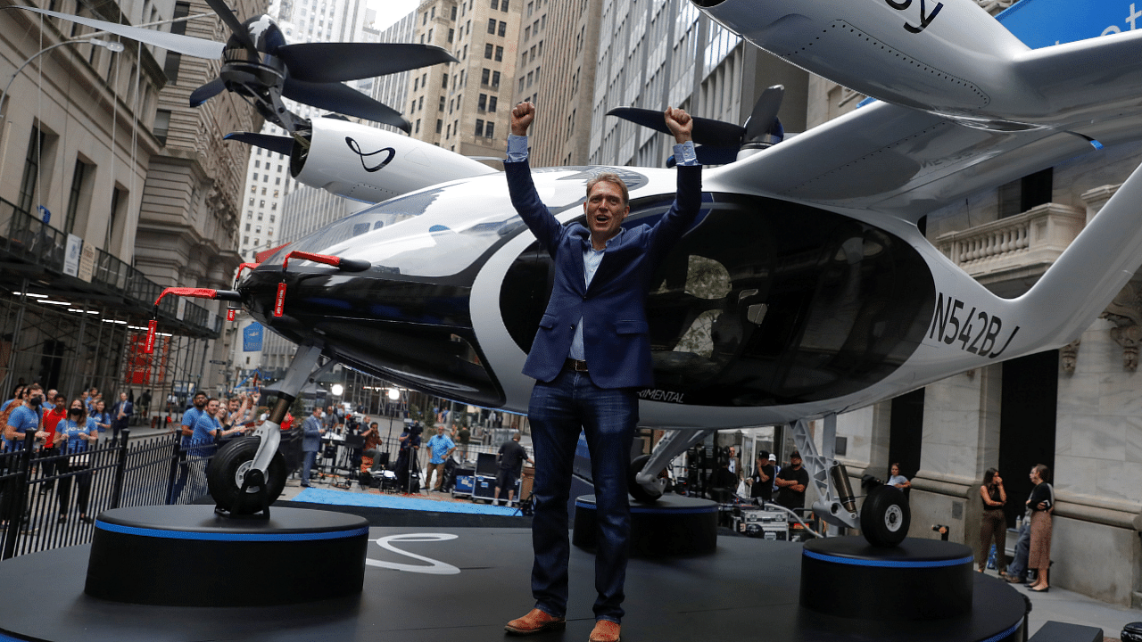 Joby Aviation founder JoeBen Bevirt poses next to a Joby Aviation Air Taxi ahead of their listing at NYSE. Credit: Reuters Photo