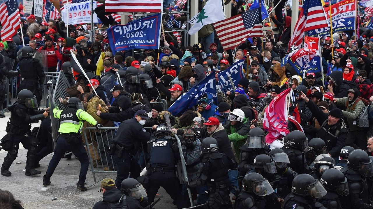 In this file photo taken on January 06, 2021 Trump supporters clash with police and security forces as they push barricades to storm the US Capitol in Washington DC. Credit: AFP Photo
