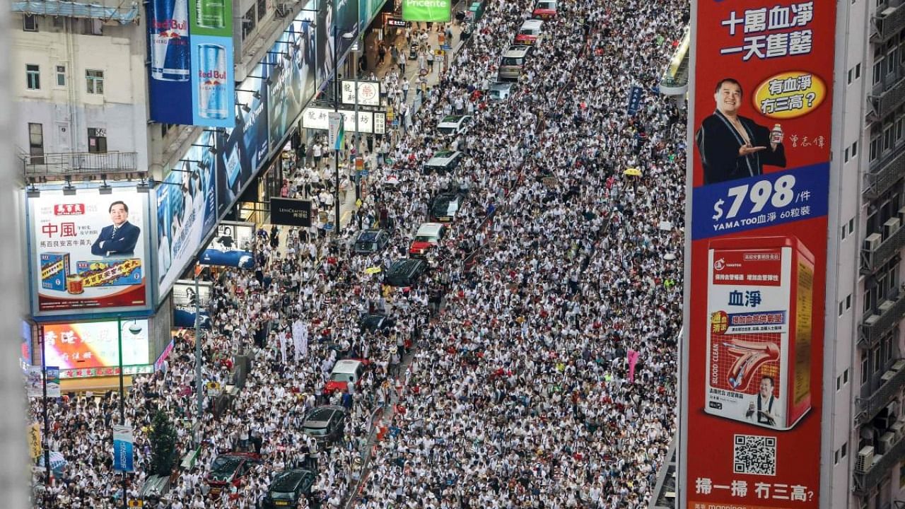 Protesters march during a rally against the controversial extradition law proposal in Hong Kong. Credit: AFP File Photo