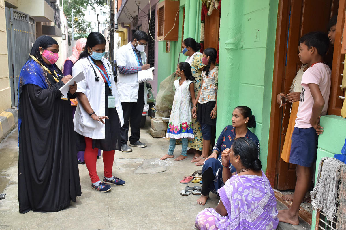 Health workers surveying homes at Chamarajpet in Bengaluru. BBMP teams have visited 88,000-plus households since last week.