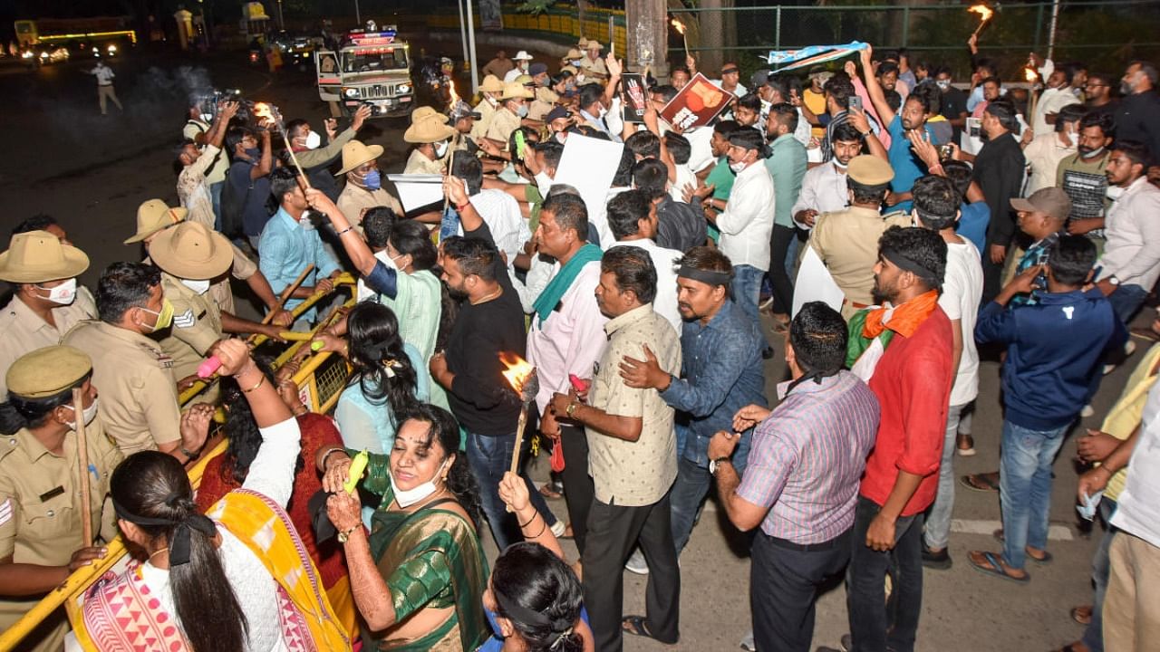 Congress party workers stage a protest against on Albert Victor Road in Mysuru on Friday. Credit: DH Photo