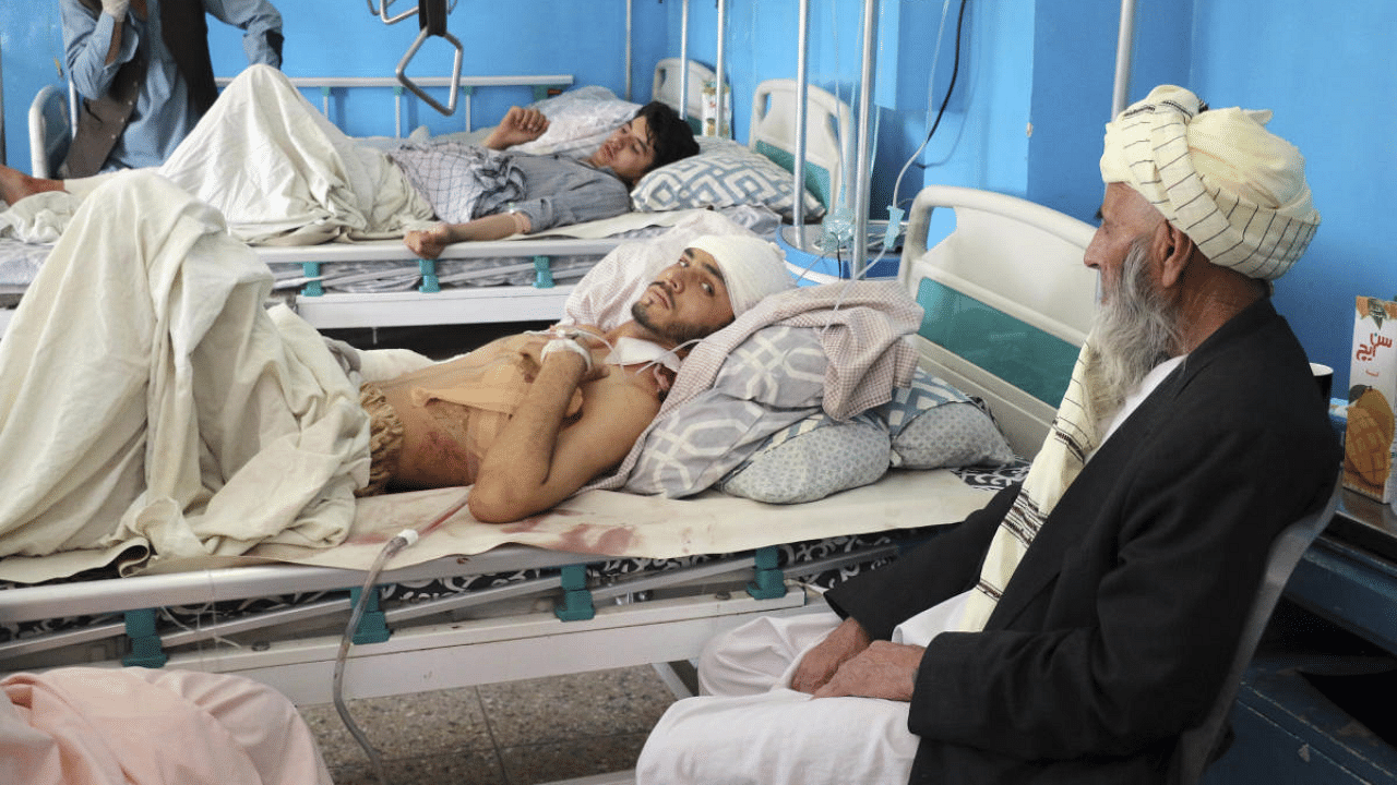 Afghans lie on beds at a hospital after they were wounded in the deadly attacks outside the airport in Kabul, Afghanistan. Credit: AP Photo