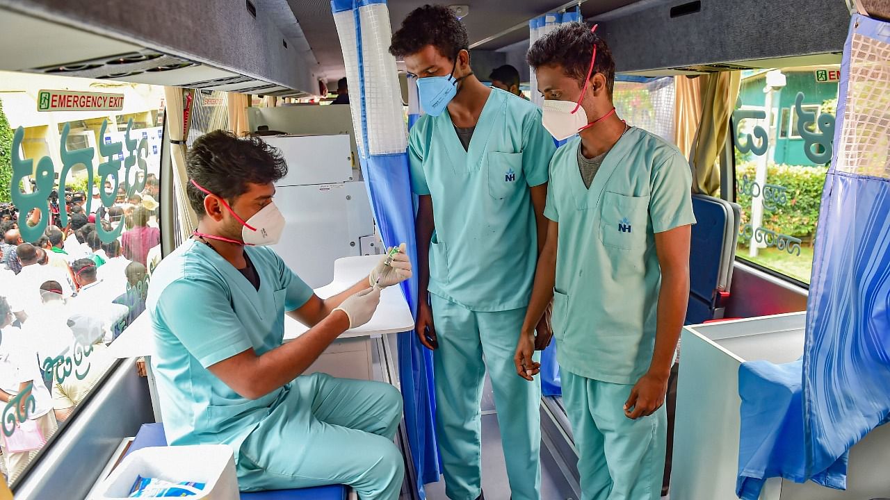 Health workers inside the vaccination bus during the inauguration of "Vaccination on Wheels" by Narayan Health City, in Bengaluru, Wednesday. Credit: PTI Photo