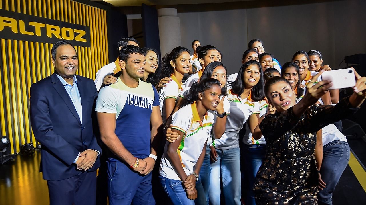 Tokyo Olympics athletes pose for selfies with President of Tata Motors, PVBU, Shailesh Chandra, after an event to hand over 'Tata Altroz hatchback to the athletes, in New Delhi, Thursday, August 26, 2021. Credit: PTI Photo
