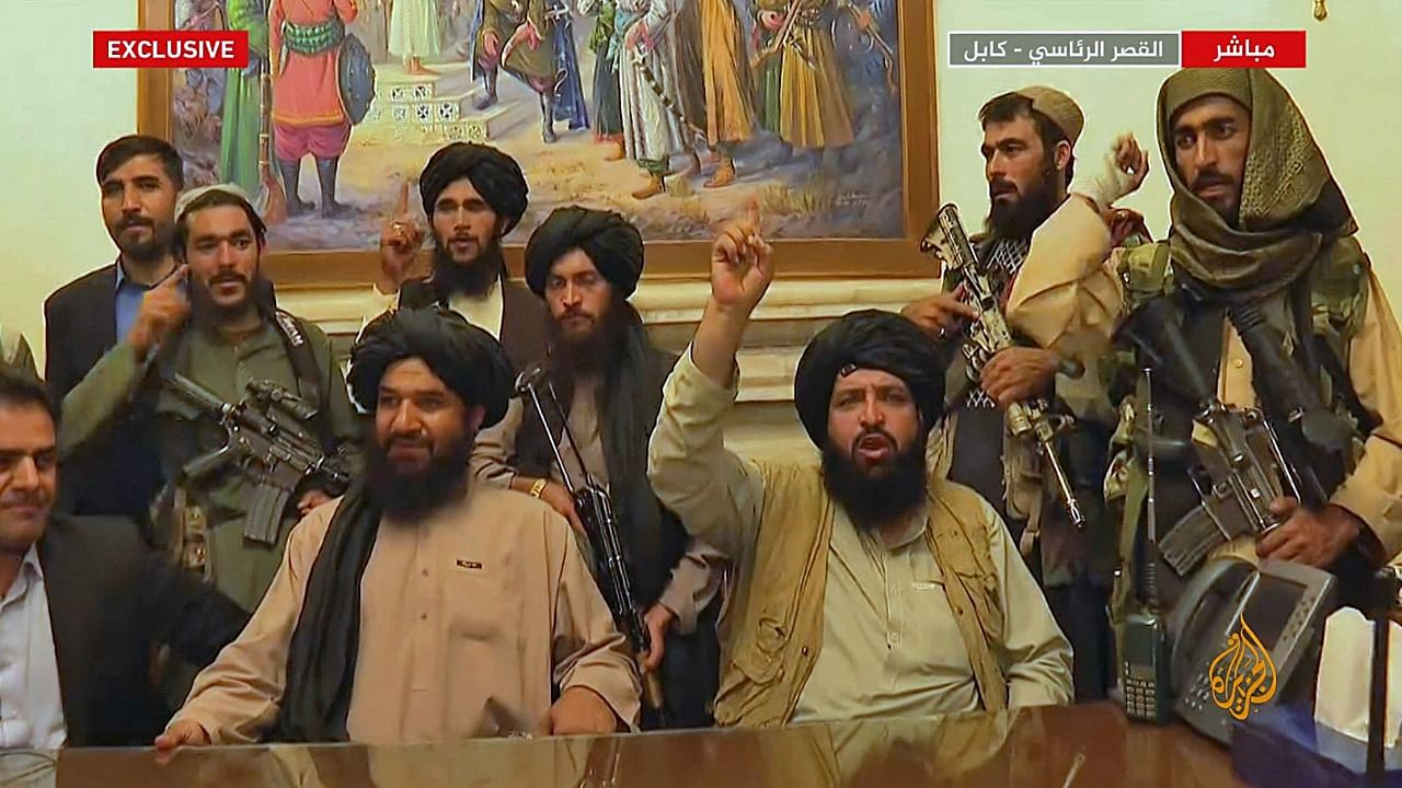 An image grab taken from Qatar-based Al-Jazeera television on August 16, 2021, shows members of Taliban taking control of the presidential palace in Kabul after Afghanistan's president flew out of the country. Credit: AFP Photo/Al Jazeera