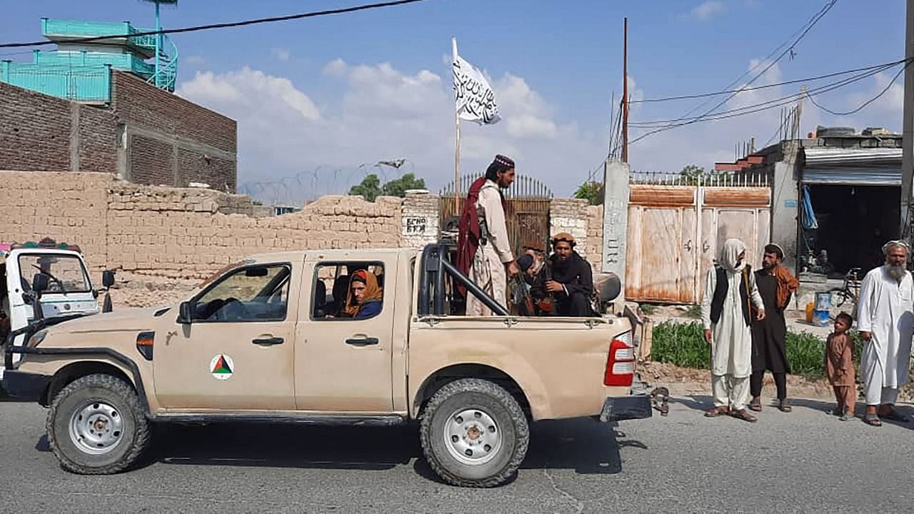 Taliban fighters drive an Afghan National Army (ANA) vehicle through the streets of Laghman province. Credit: AFP Photo