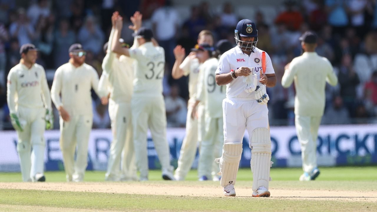 Rishabh Pant walks off after being caught by England's Craig Overton. Credit: Reuters Photo