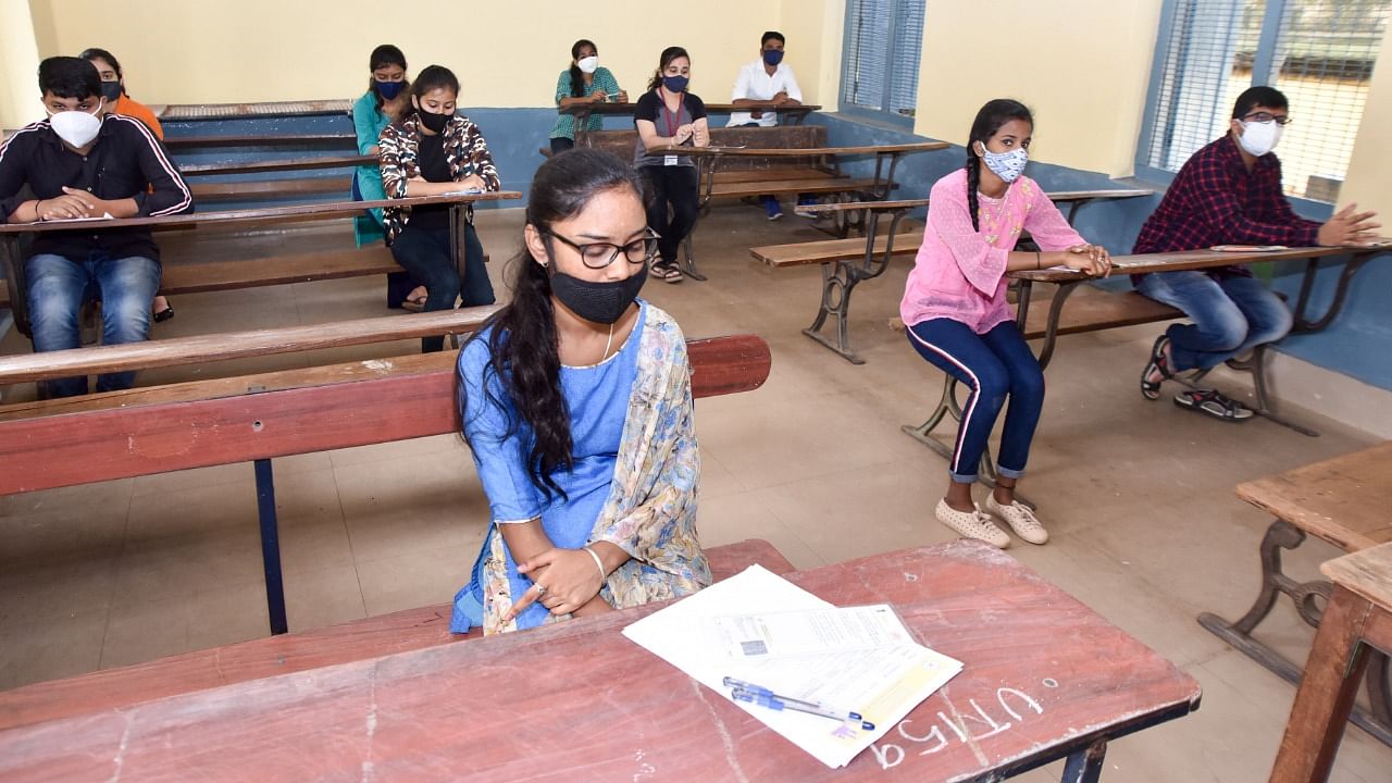 The staff at the examination centres checked the body temperature of the students at the entrance using thermal scanning. Credit: DH Photo/Savitha B R