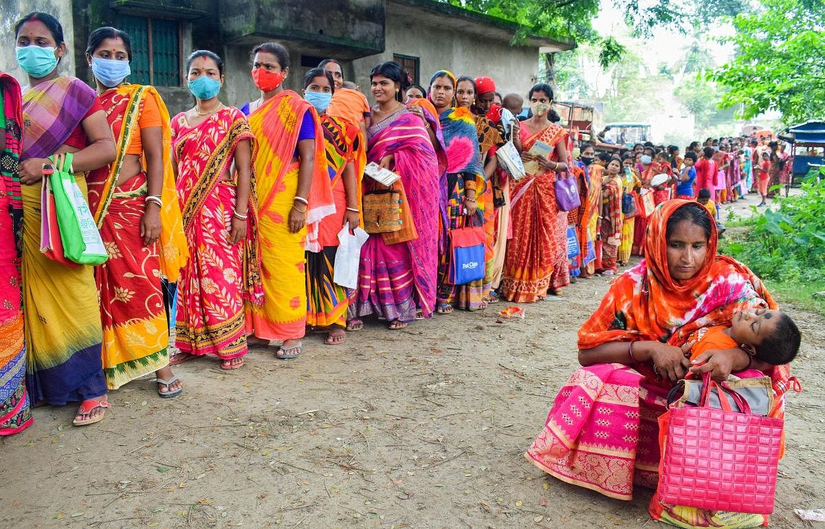 Beneficiaries wait in a queue to receive Covid-19 vaccine dose, at a government hospital in Nadia. Credit: PTI Photo
