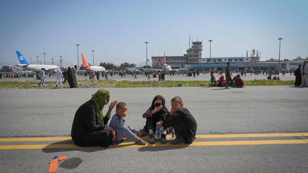 People waiting to get evacuated at Kabul airport. Credit: AFP File Photo
