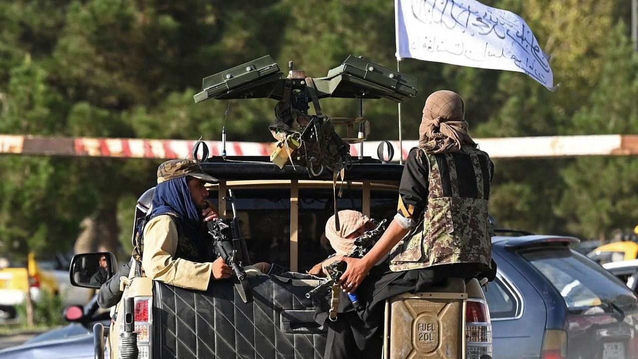 Taliban fighters in a vehicle patrol a street in Kabul. Credit: AFP Photo