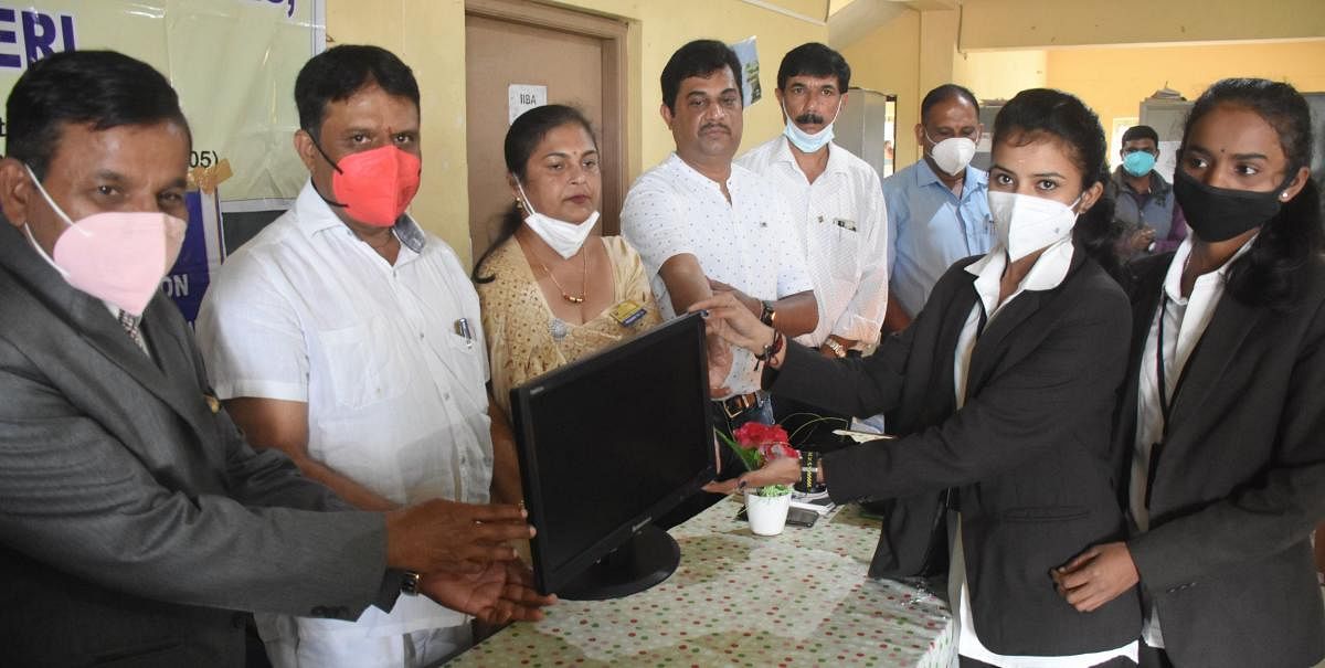 Rotary Misty Hills hands over five computers to MLA M P Appachu Ranjan, to be given to Government First Grade Women's College in Madikeri. Credit: DH Photo