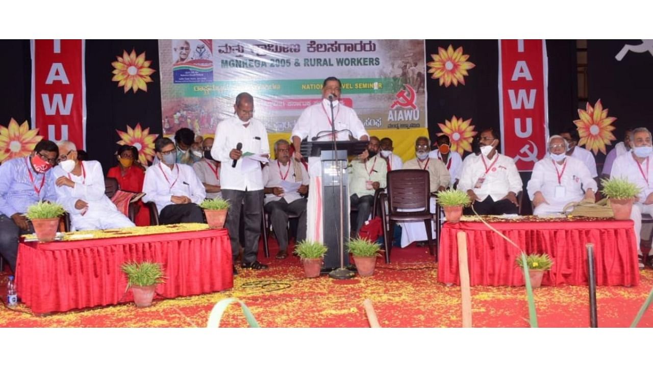 Excise and Rural Development Minister of Kerala M V Govindan Master speaks during the national-level symposium on 'NREGA and Rural Workers' organised by All India Agricultural Workers Union (AIAWU) and Karnataka Prantha Krushi Koolikarara Sangha in Mandya. Credit: DH photo