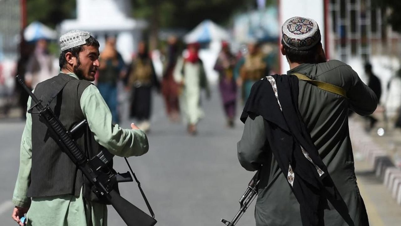 Taliban fighters walk at the main entrance gate of Kabul airport in Kabul on August 28, 2021. Credit: AFP Photo