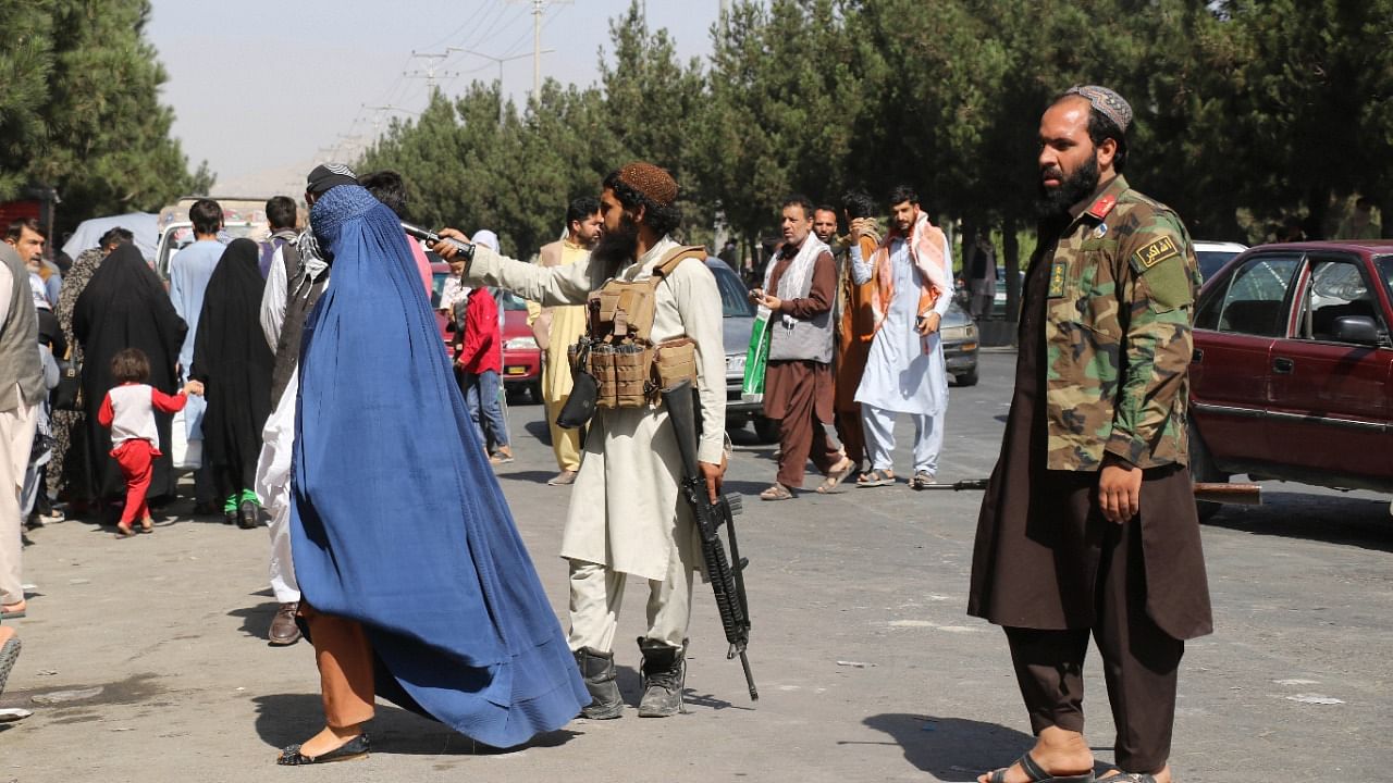 Taliban fighters stand guard outside the airport after Thursday's deadly attacks outside the airport in Kabul, Afghanistan. Credit: AP/PTI photo