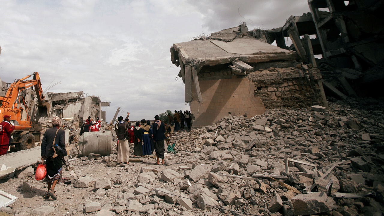 People and the Red Crescent medics inspect the site of strikes. Credit: Reuters Photo