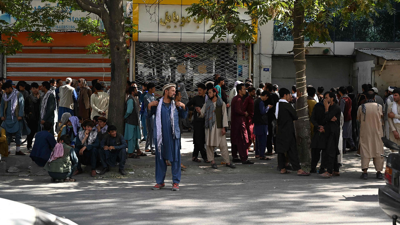 Bank account holders gather outside a closed bank building in Kabul. Credit: AFP Photo