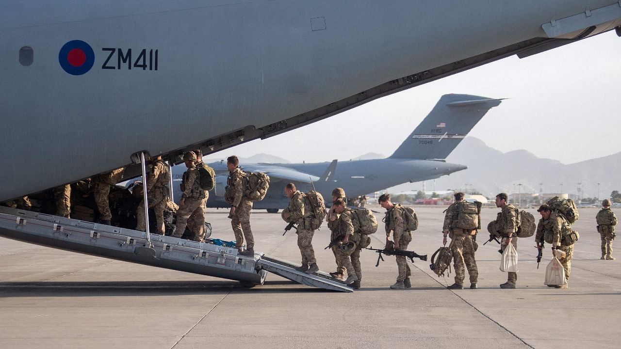 British military personnel board a Royal Air Force A400M aircraft ahead of departing Kabul Airport where they had been deployed as part of Operation PITTING to evacuate British nationsl and eligible Afghans under the Afghan Relocation and Assistance Program. Credit: AFP Photo/Crown copyright 2021/MOD/Jonathan Gifford