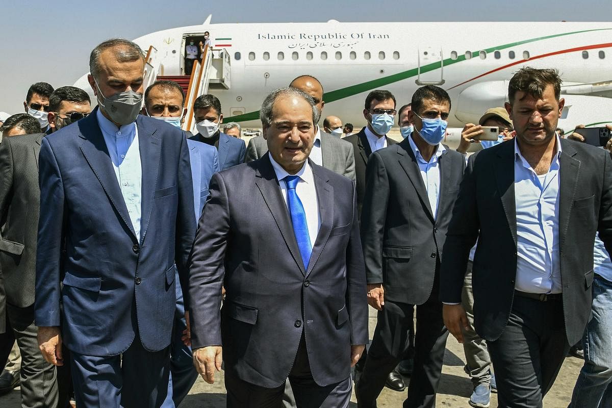 Syria's Foreign Minister Faisal Mekdad, center left, receives Iran's new Foreign Minister Hossein Amir-Abdollahian, left, in Damascus, Syria. Credit: AP Photo