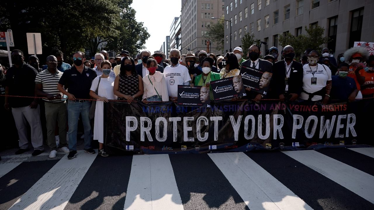 Lawmakers and activists including (L-R) Andrea Waters King (5th from left), Yolanda Renee King, the granddaughter of Rev. Martin Luther King Jr. , Rev. Al Sharpton (3rd L, front row), US Rep. Sheila Jackson Lee (D-TX), Rep. Terri Sewell (D-AL) and Rep. Al Green (D-TX), attend the “March On for Washington and Voting Rights” on August 28, 2021 in Washington, DC. Credit: AFP Photo