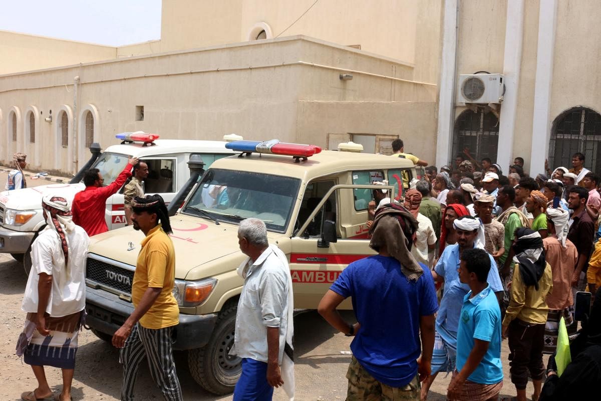 People gather as ambulances transport casualties of strikes on Al-Anad air base to the Ibn Khaldun hospital. Credit: AFP Photo