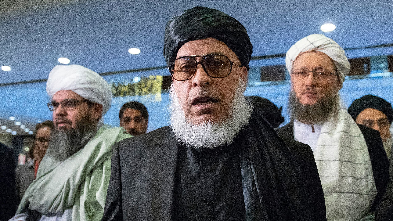 Taliban political chief Sher Mohammad Abbas Stanikzai, center, walks in a hall as he attends the "intra-Afghan" talks in Moscow, Russia. Credit: AP Photo