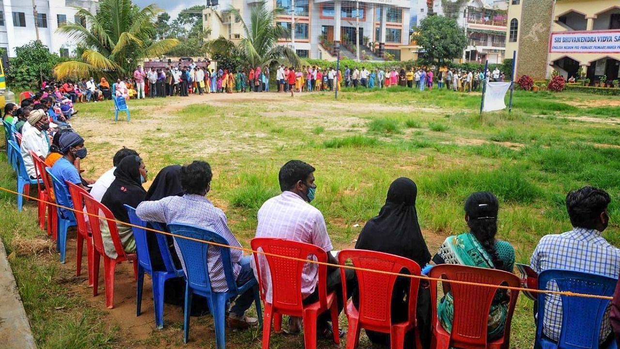 People wait in a long queue for Covid-19 vaccine in Chikkamagaluru, Karnataka, on August 27, 2021. Credit: PTI File Photo