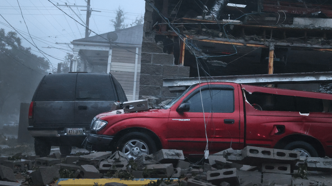 Vehicles are damaged after the front of a building collapsed during Hurricane Ida. Credit: AFP Photo