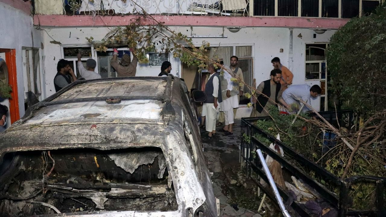 Afghan people are seen inside a house after US drone strike in Kabul, Afghanistan. Credit: AP/PTI Photo