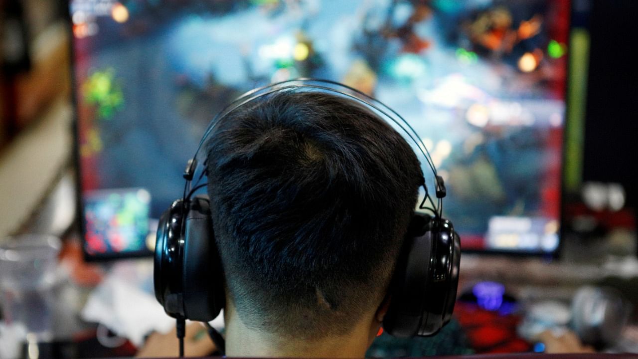 A man plays online game on a computer at an internet cafe in Beijing, China. Credit: Reuters Photo