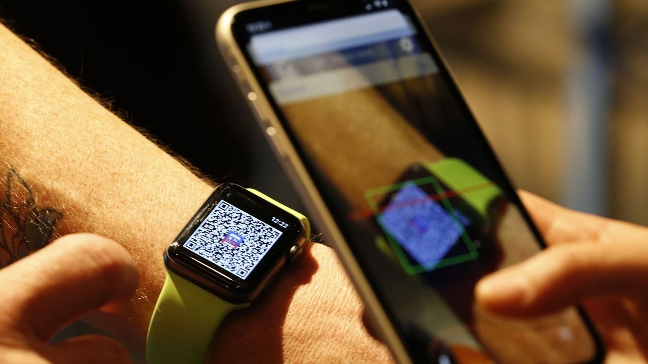 A person scans a QR code on an Apple Watch. Credit: AFP File Photo