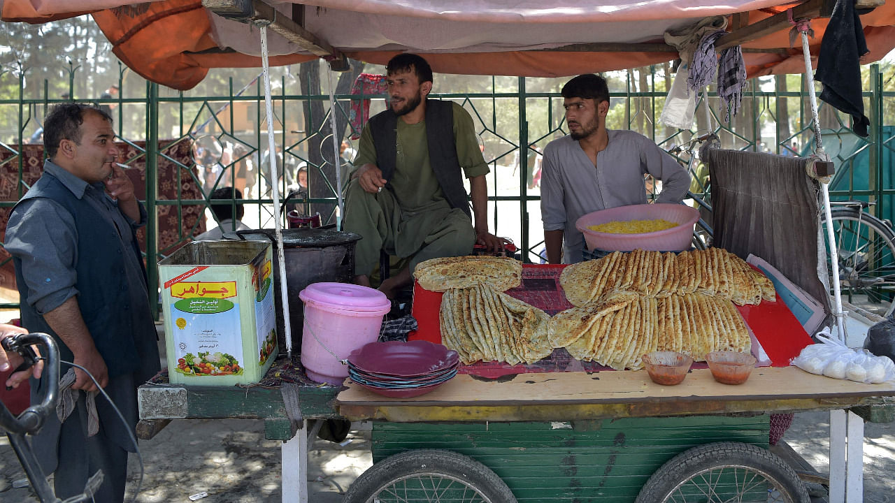 Afghan vendors selling 'Bolani' (fried bread stuffed with potatoes) wait for customers at a roadside stall in Kabul. Credit: AFP File Photo