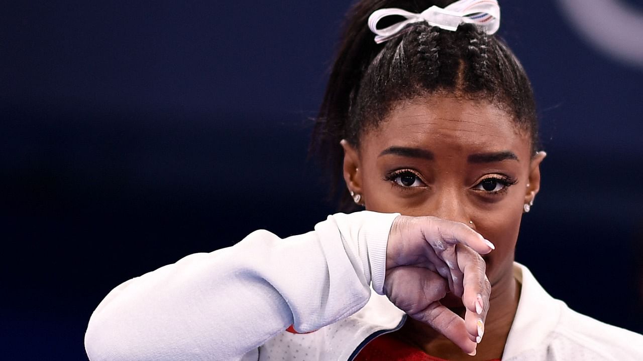 Simone Biles gestures during the artistic gymnastics women's team final during the Tokyo 2020 Olympic Games at the Ariake Gymnastics Centre in Tokyo. Credit: AFP Photo